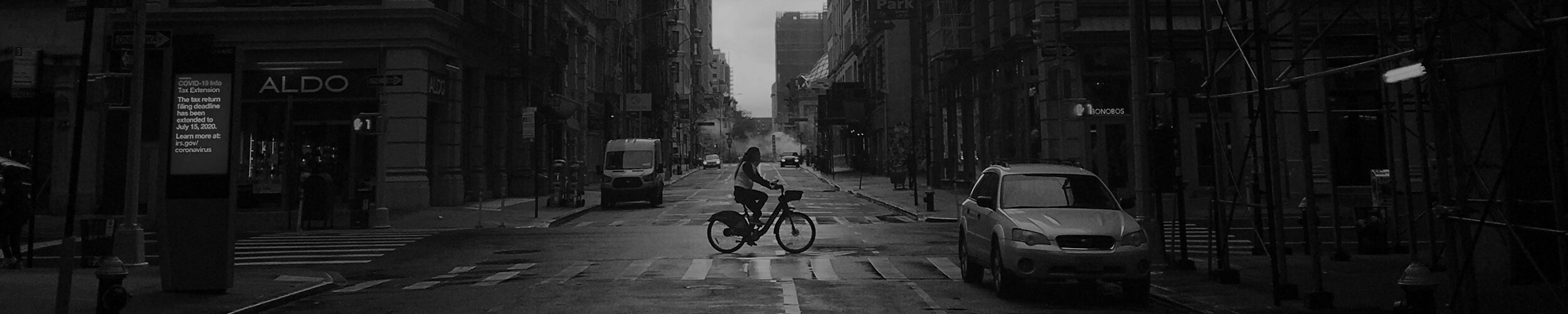 A nearly empty Manhattan street with a single cyclist, spring 2020