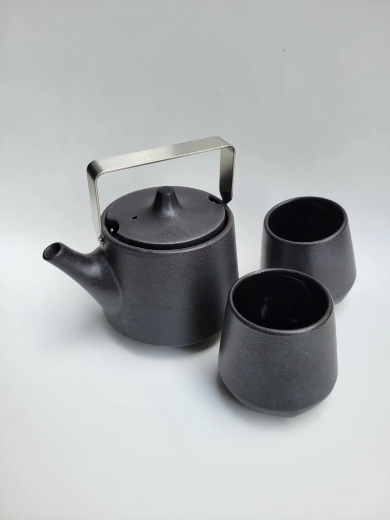 Ceramic tea kettle with two cups