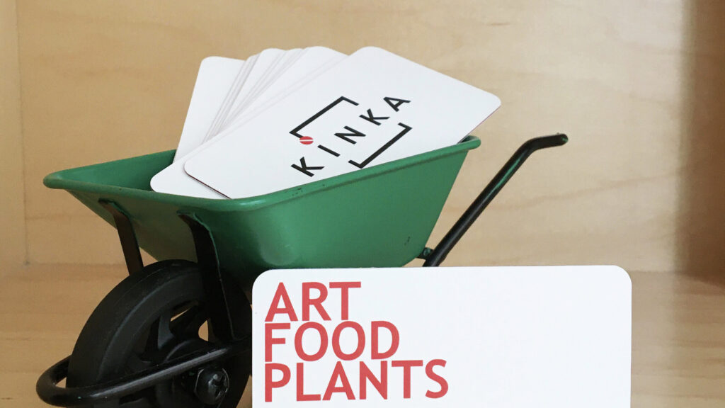 KINKA business cards in a miniature green wheelbarrow